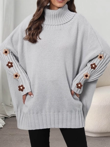 Detailed view of grey high-neck knit sweater with 3D floral crochet on sleeves