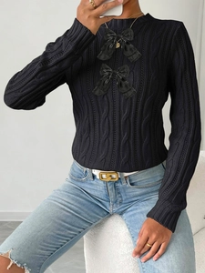 Women's black cable knit sweater with elegant bow details and classic round neckline