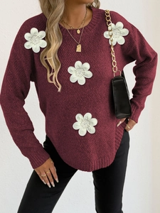 Detail of burgundy knit sweater featuring white 3D floral embroidery and beads