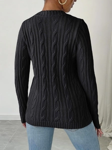 Detail of black cable-knit sweater back view with ribbed cuffs and crew neck styling