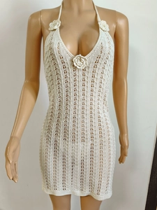 Detail of crochet floral applique on a cream halter neck knit cover-up dress