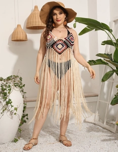 Detail of crochet beach cover-up featuring colorful geometric patterns and long fringes