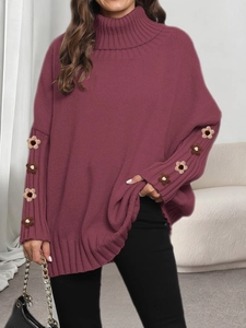 Detailed view of hand-crocheted floral stitching on purple oversized turtleneck sweater