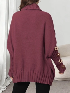 Detail of burgundy turtleneck sweater featuring 3D crochet floral patches on sleeves