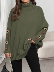 Detail view of dark green turtleneck sweater featuring thick knit and 3D floral crochet sleeves