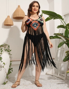 Detail of colorful crochet knit pattern and long black tassels on a beach cover-up dress
