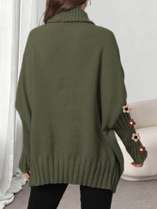 Detail view of olive green knit sweater featuring floral crochet on loose sleeves