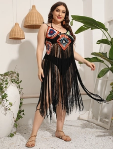 Detail shot of boho crochet beach cover-up with colorful floral patterns and long tassels