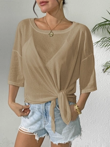 Detail of sheer khaki mesh top featuring a knotted waist design and lightweight texture