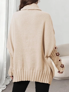 Oversized beige turtleneck sweater featuring handmade crochet flower details on sleeves