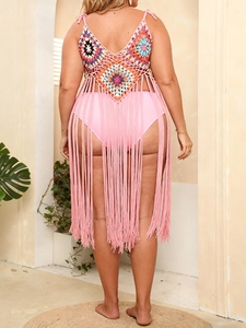 Detail of bohemian crochet beach cover-up featuring colorful geometric patterns and long tassels