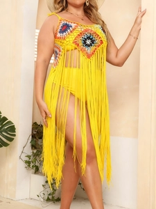 Detail of yellow handmade crochet beach cover-up with colorful granny square patterns