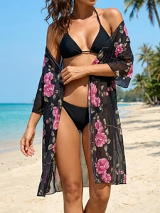 Detail of sheer black floral chiffon cover-up with realistic pink rose patterns for beachwear