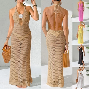 Detail of crochet halter dress featuring 3D flower accent and knit hollow-out texture