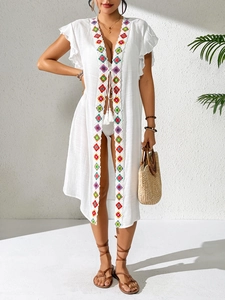 White beach cover-up with colorful crochet embroidery and tassel ties in resort style