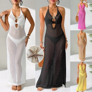 Detail of crochet beach maxi dress featuring gold starfish decor and hollow knit texture
