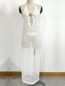 Detail of white crochet halter dress with metal starfish ornament and teardrop cutout
