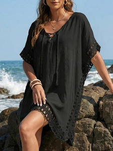 Detail of crochet lace trim and V-neck tie on black bohemian beach cover-up dress