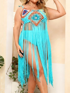 Detail view of the colorful crochet bodice and long fringe tassels on a beach cover-up