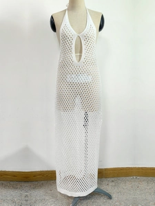 Close-up of white crochet beach dress with halter neck and teardrop cutout details
