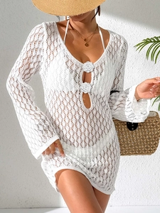 Close-up of white crochet lace beach cover-up featuring long flared sleeves and 3D floral detail