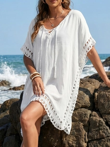 White boho crochet beach cover-up with V-neck tassels and delicate lace details