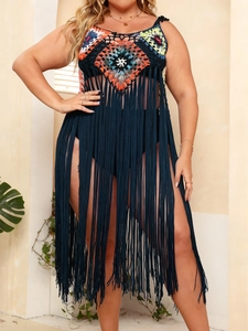 Detail of colorful crochet bodice and long black tassels on bohemian beach cover-up dress