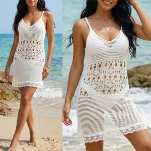 Detailed view of white crochet lace beach cover-up dress with intricate hollow-out floral patterns
