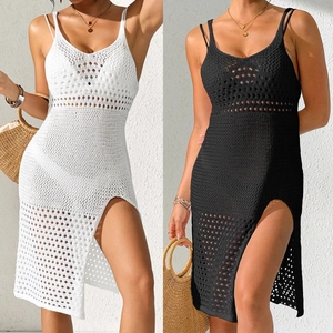 Detail of crochet beach cover-up showing delicate hollow-out knit patterns and side slits