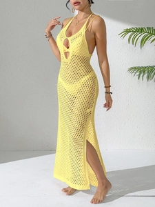 Detail of yellow crochet beach dress featuring knit cut-out patterns and side slit design