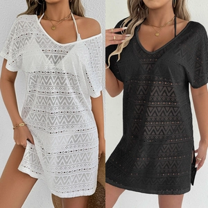 Detail view of hollow crochet pattern on white and black beach cover-up dresses
