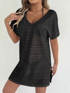 Detailed texture of black crochet lace beach cover-up with V-neck and hollow out patterns