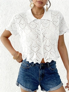 Close-up of white heart hollow-out knit cardigan with polo collar and buttons