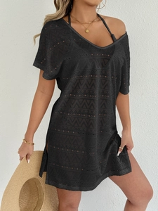 Close-up detail of black crochet beach cover-up featuring geometric hollow patterns