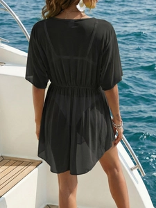 Rear view of black sheer mesh beach cover-up with elastic waist on a sunny yacht