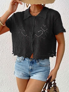 Detail of black short sleeve knit cardigan featuring heart-shaped cutout pattern