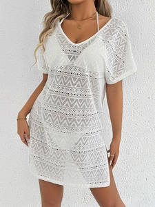 Close-up of white crochet knit beach cover-up showing intricate geometric hollow patterns