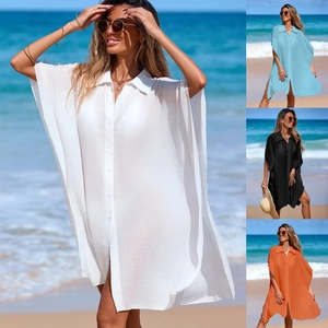Close-up of semi-transparent loose beach cover-up with polo collar and side slits