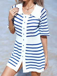 Detail of blue and white striped knit dress featuring a polo collar and blue buttons