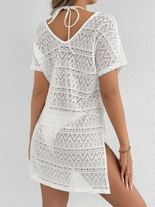 Detail of white crochet beach cover-up featuring side slit and open back lace design