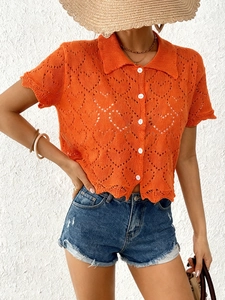 Detail of orange heart hollow knit polo shirt with buttons for a summer beach look