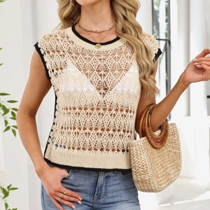 Detailed macro view of beige hollow-out crochet knit vest with black contrast piping