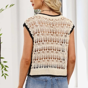 Detail of beige hollow knit vest with black trim and diamond pattern from back view