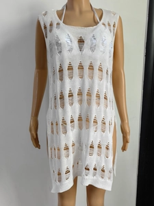 Detail of white crochet knit cover-up dress featuring hollow textures and side slit design