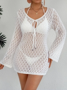 Détail du cache-maillot blanc au crochet avec motifs géométriques et col en V à nouer