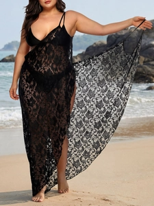 Close-up of floral crochet lace fabric on a black beach cover-up sundress for women