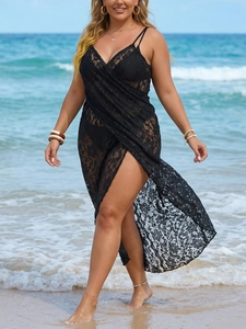 Detail of sheer black lace beach cover-up with adjustable straps and wrap silhouette