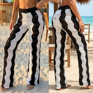 Detail of crochet knit beach trousers with black and white wavy stripes and high waist