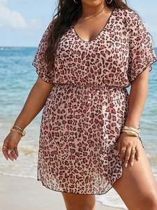 Leopard print V-neck maxi beach dress with high waist and side slit on a sunny beach