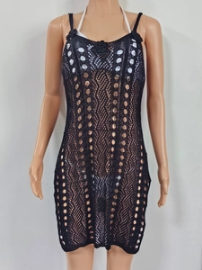Detail of black crochet beach cover-up featuring 3D floral accents and hollow knit